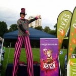 Stretch on four foot tall stilts at the Colorado AIDs Walk in Denver's Cheeseman Park.