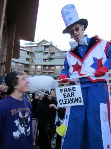 Stretch the nine foot clown in his Americana Costume. Never before has ear cleaning been so much fun!